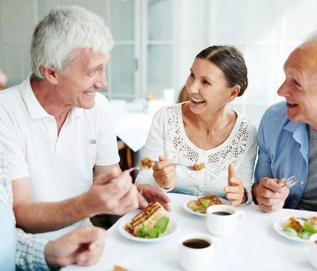 group of seniors enjoy a desert