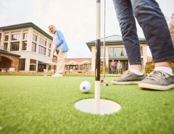 R1 BH Selects R1 (1) Page 52 Image 0005 senior friends playing a round of golf outside at Beacon Hill Senior Living Community