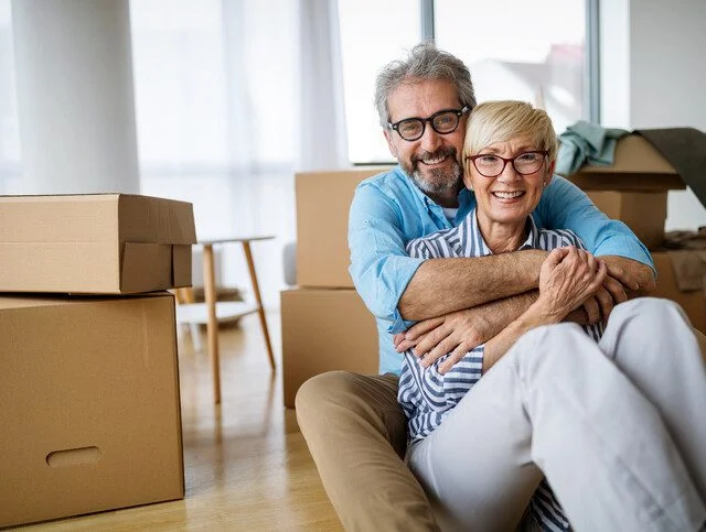 Portrait of happy smiling senior couple in love moving in new home