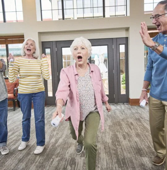 seniors playing with the game consoles on campus