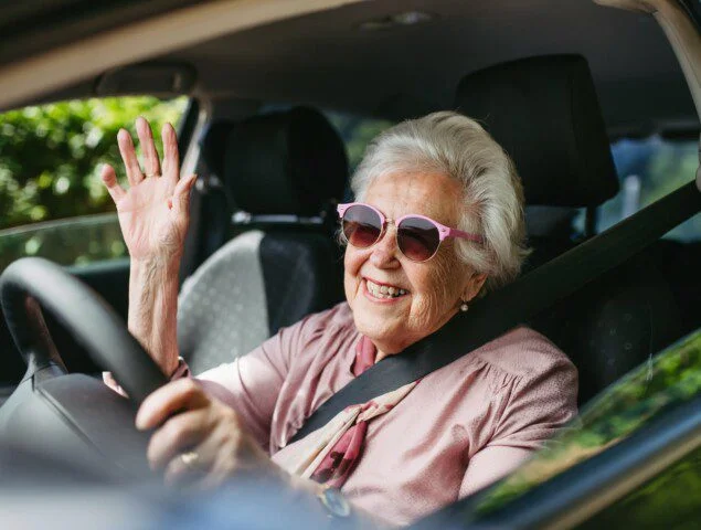Senior Lady Driving A SUV
