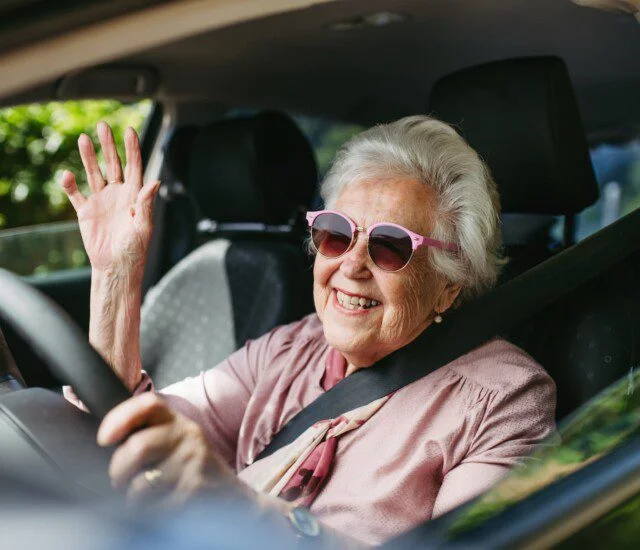 Senior Lady Driving A SUV