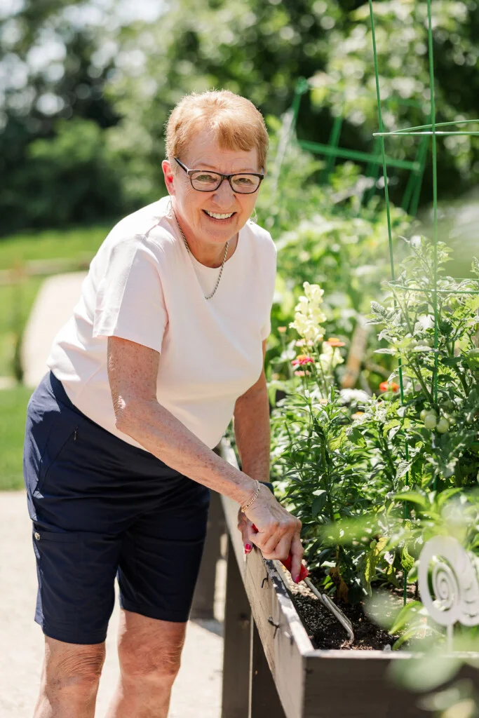 Diane Minges tending her garden on the Beacon Hill campus