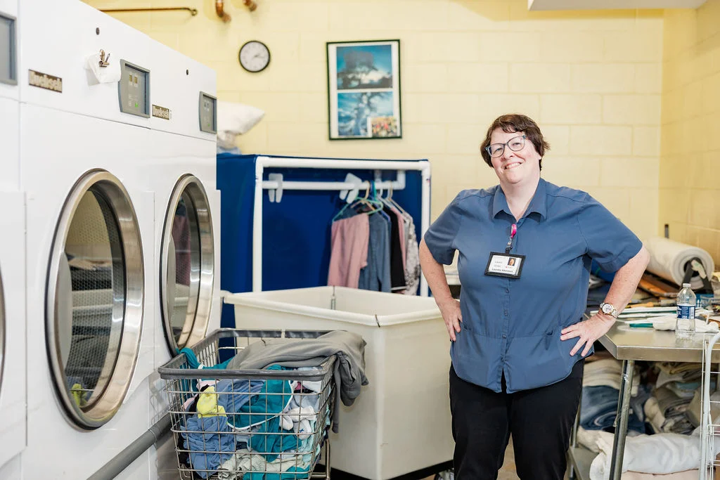 Laundry Attendant Laurie Winter in the laundry room at Beacon Hill in Lombard, Illinois