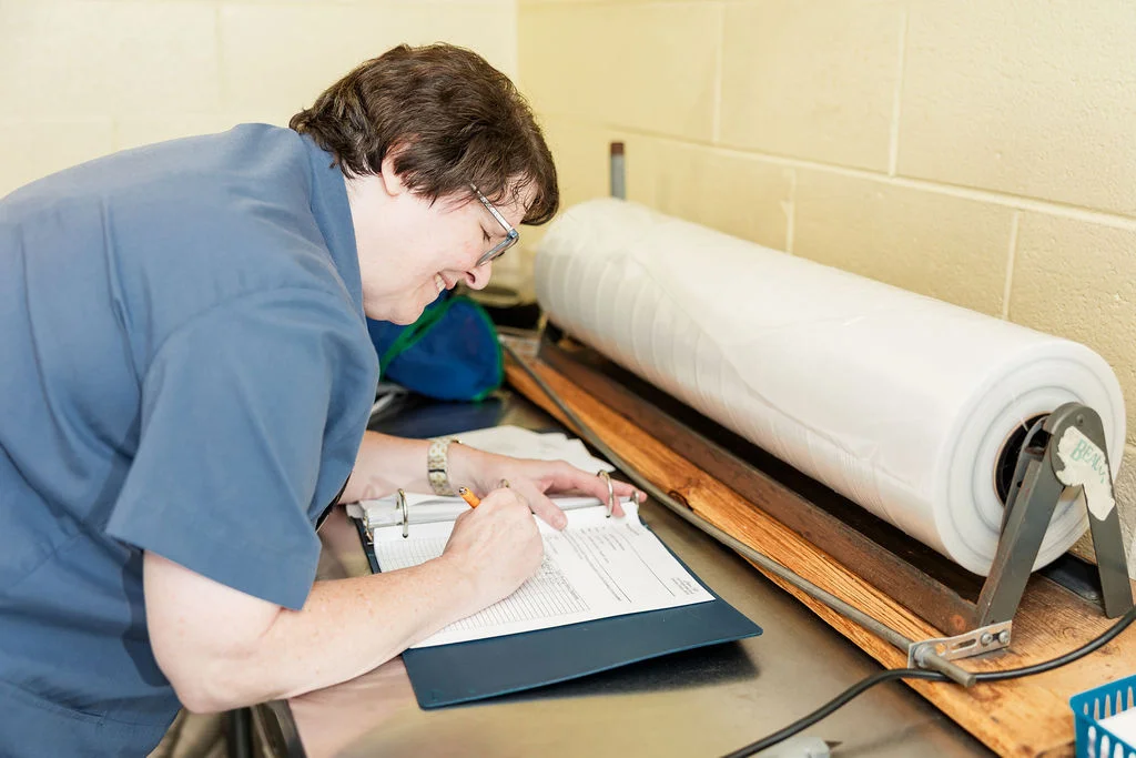 Beacon Hill team member Laurie Winter tracking laundry service records