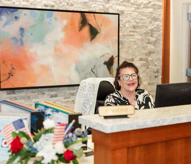 Concierge Sandy Rojas at the front desk at Beacon Hill in Lombard, Illinois
