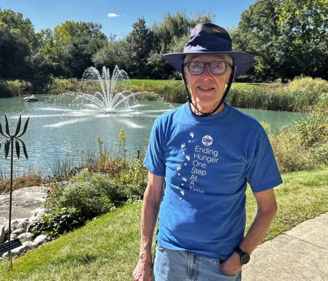 Resident Dan Jares by the pond at Beacon Hill in Lombard, Illinois