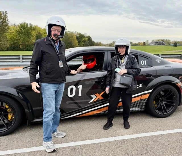 Beacon Hill residents beside a Dodge Hellcat at Autobahn Country Club in Joliet, Illinois