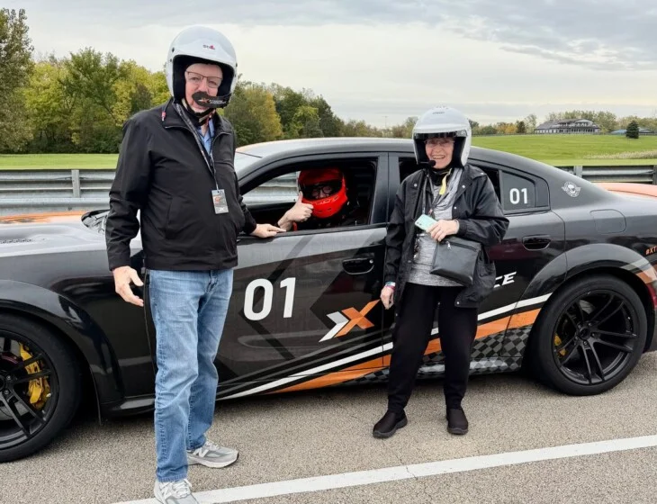 Beacon Hill residents beside a Dodge Hellcat at Autobahn Country Club in Joliet, Illinois