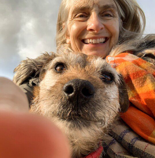 senior woman and her dog take close-up selfie