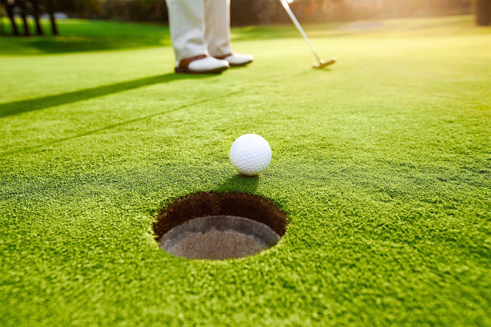 close-up of a golf ball near the hole