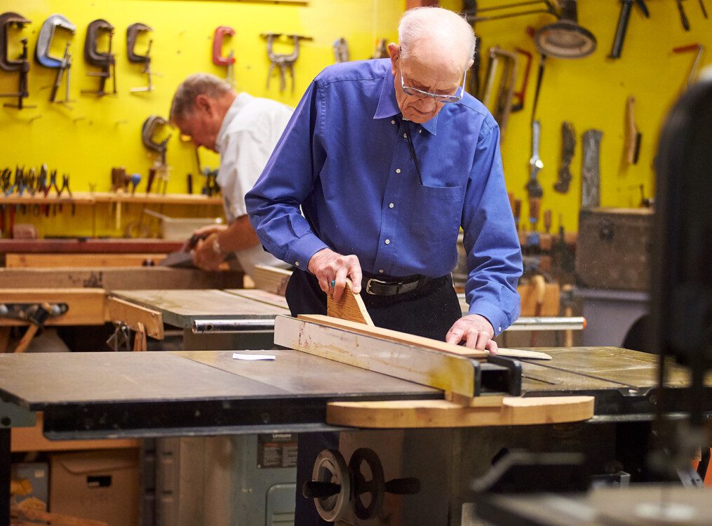 Senior man completing a woodworking project