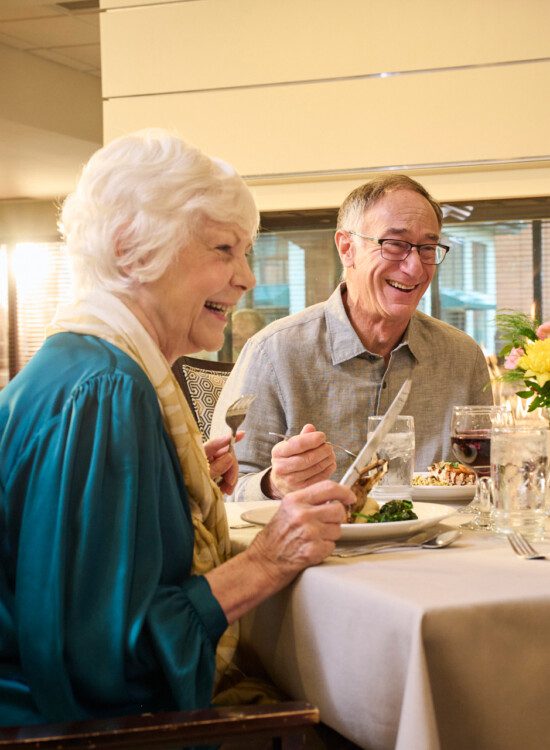 group of well-dressed senior friends enjoying a meal together in an elegant setting