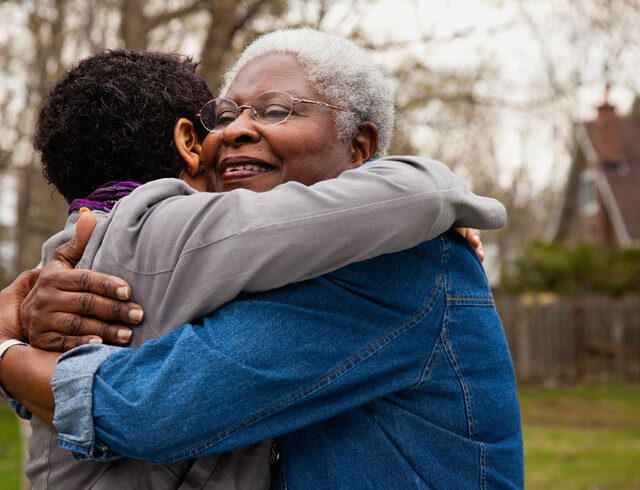 Senior woman hugging her daughter