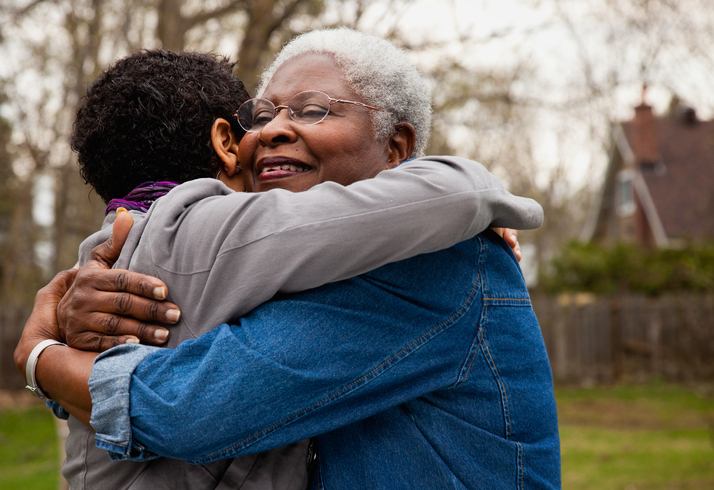 Senior woman hugging her daughter