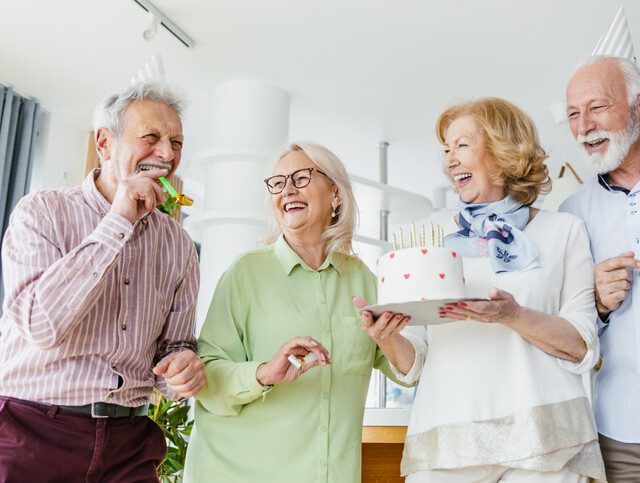 Senior friends celebrating a birthday together.