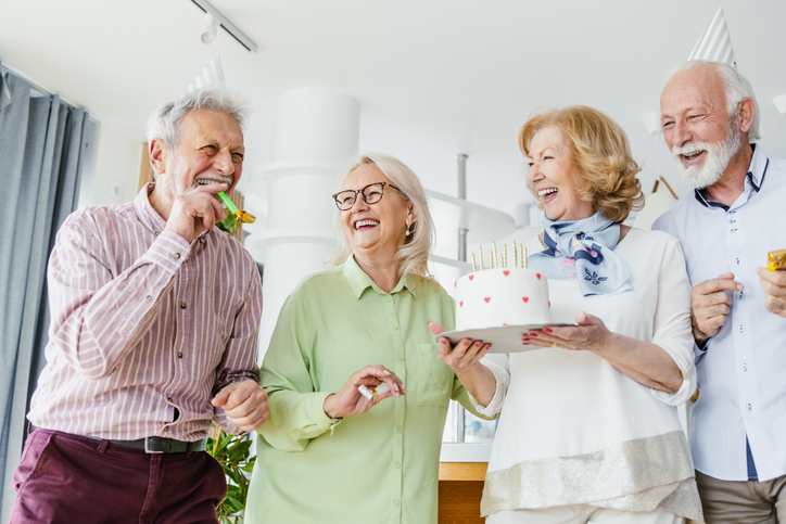 Senior friends celebrating a birthday together.