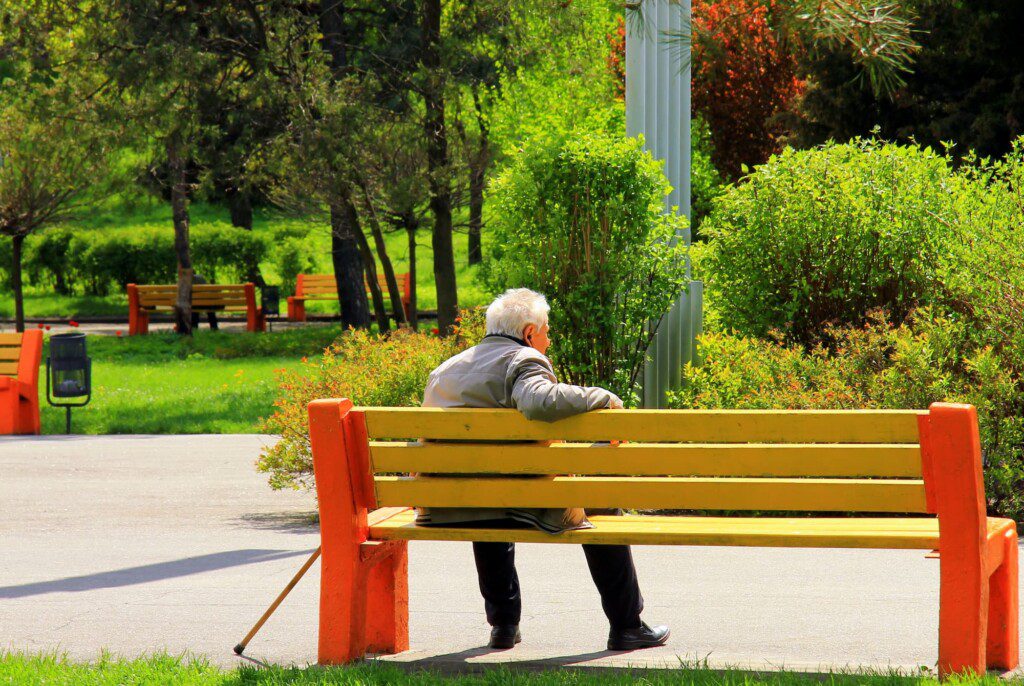 Senior man enjoying a park bench at the outdoor campus of Beacon Hill