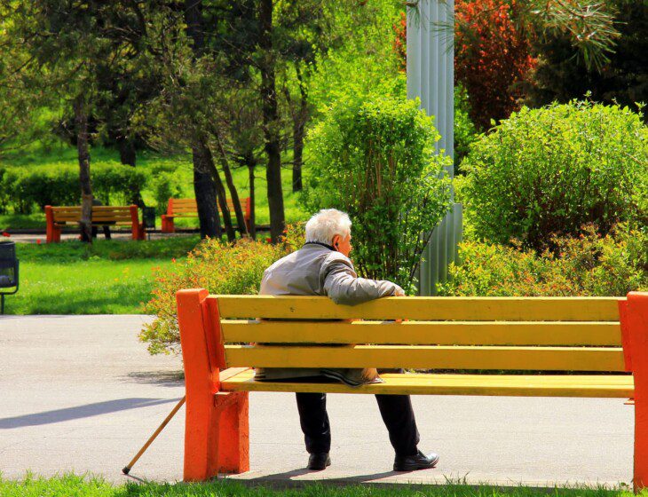 Senior man enjoying a park bench at the outdoor campus of Beacon Hill